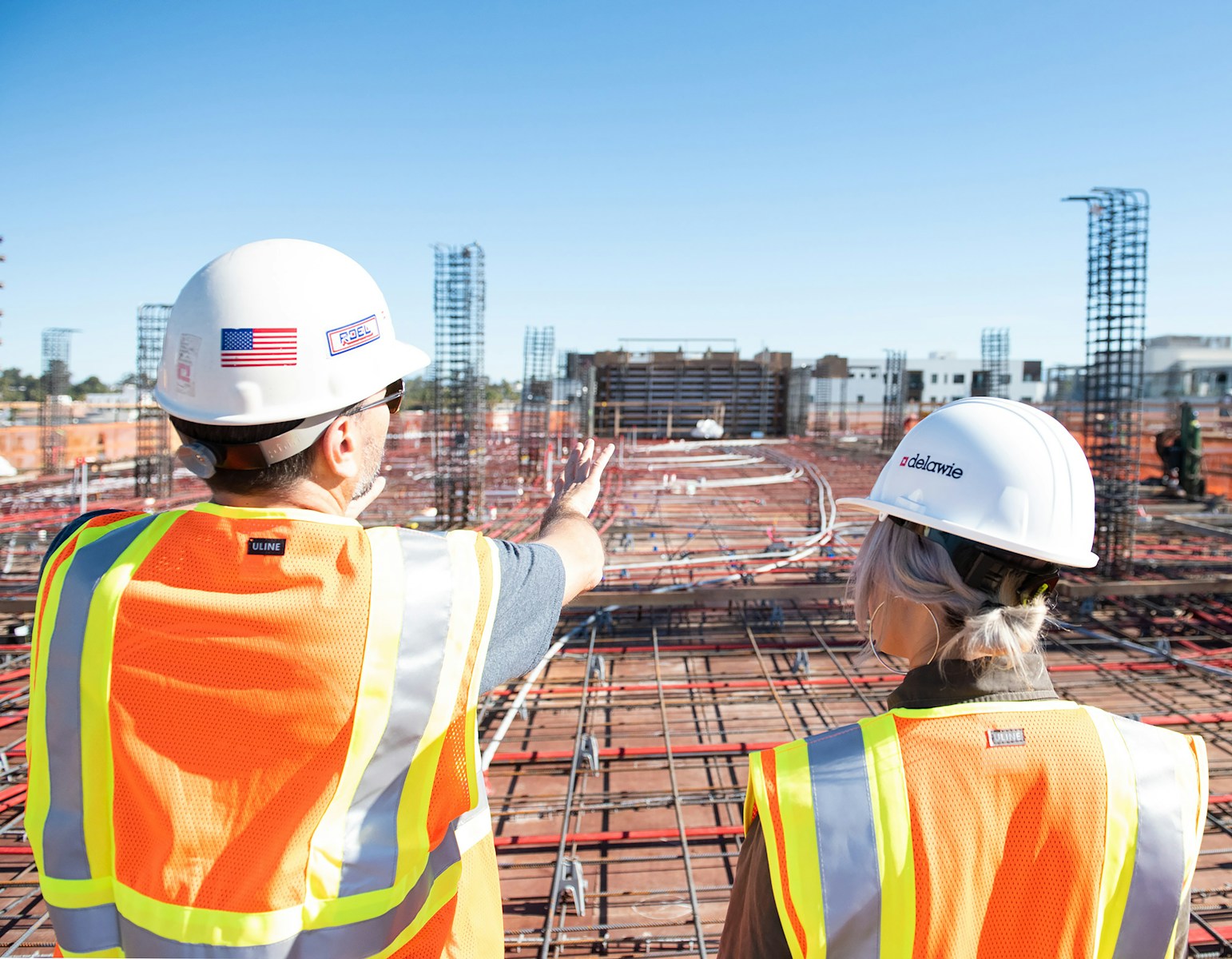 man in white hard hat standing on brown wooden dock during daytime, contactors